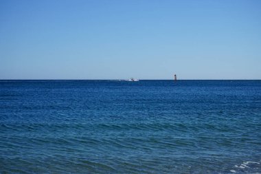 Akdeniz 'de Rodos adasının açığında bir motorlu tekne içinde insanların bulunduğu şişme bir salı çekiyor. Kolympia, Yunanistan  