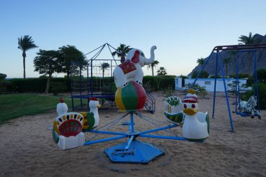 Children's playground in the tourist recreation area. Dahab, South Sinai Governorate, Egypt  clipart