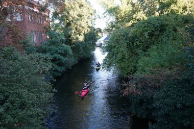 Schlossgraben 'de iki kano denize açılıyor. Baidarka ya da Aleutian kanosu sert bir uzay çerçevesi üzerinde yumuşak deriden oluşan bir su gemisidir. Berlin, Almanya 
