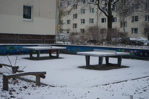 Table tennis tables in the yard under the snow in winter. Berlin, Germany
