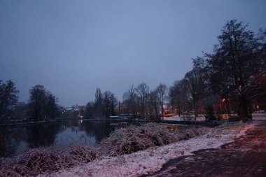 Snowy banks of the river Spree in the evening in December. Berlin, Germany