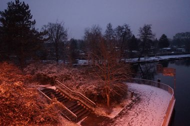 Snowy banks of the river Spree in the evening in December. Berlin, Germany
