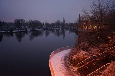 Snowy banks of the river Spree in the evening in December. Berlin, Germany
