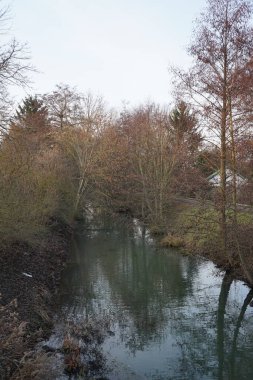 Shallow river Wuhle and surroundings with beautiful vegetation in December. Berlin, Germany