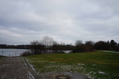 Beautiful Biesdorfer Baggersee lake surrounded by winter vegetation in January. Berlin, Germany