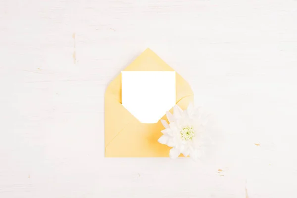 Yellow Envelope Blank Sheet White Dahlia Flower White Wooden Table — Stockfoto