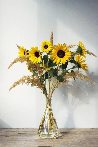 Autumn bouquet with sunflowers and pampas grass. Still life.