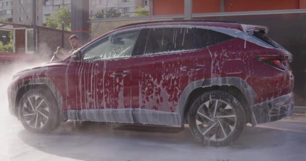 Young Man Washes Red Car Self Service Car Wash — Video Stock