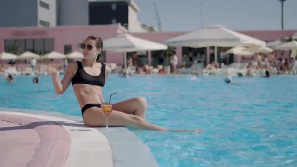 Miss Black Swimsuit Pool Has Cocktail Her Side Greets Someone — Wideo stockowe