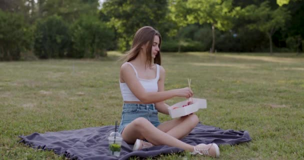 Young Lady Brown Hair Dressed White Sitting Grass Park Puts — Video