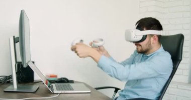 business man who during the coffee break relaxes in a game with virtual achelers. Modern office and state-of-the-art technologies. Job concept that offers you many opportunities.