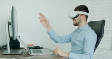 Mechanical engineering student wearing virtual reality headset, uses VR technology for industrial design, development, prototyping in robotics. High tech concept