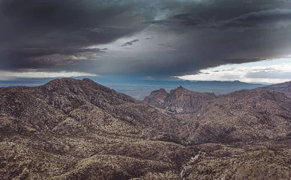 Ominous dark cloud over Tucson Mountains, Arizona. Monsoon season. Storm approaching.