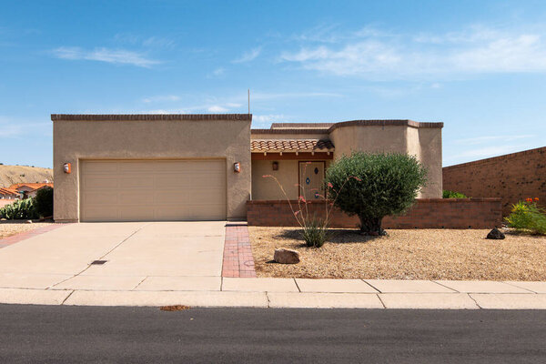 New modern Southwestern style house with flat roof, stucco home in Green Valley, Arizona with xeriscape landscaping.