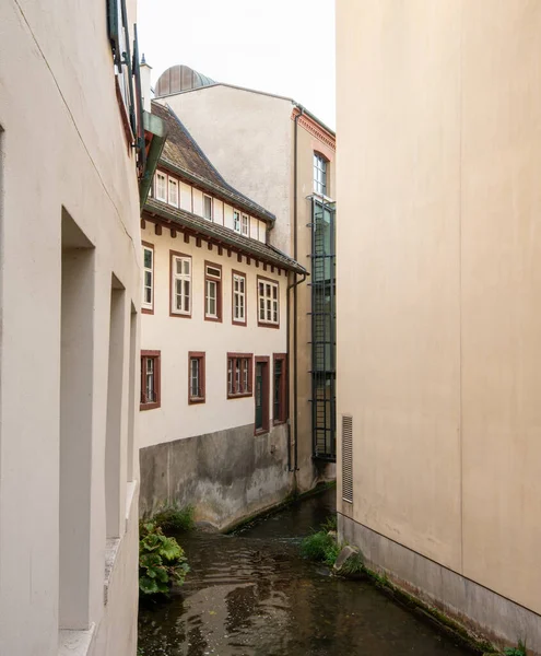 Old homes and neighborhood of St. Albans in Basel, Switzerland, Europe. River Bird flows between two buildings.