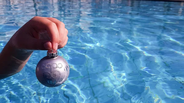Child Holding Christmas Tree Toy Form Silver Ball Blue Water — Stock Photo, Image