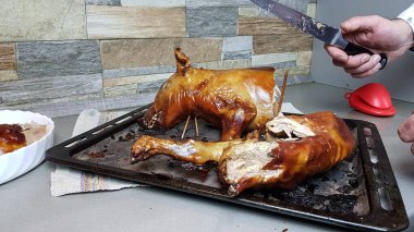 Aşçı, fırında pişirilmiş bir domuzu parçalara ayırır. Masaya güzel bir domuz eti tabağı koydum. Yavru domuz..