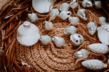 Örülmüş bir halıda Noel konileri. Eko-stil noel baloları. Köy Noel 'i konsepti. Geçmiş kartpostalları. Boho tarzında köknar dalları