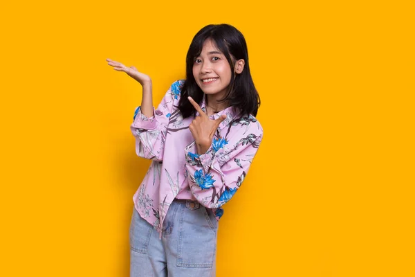 Young Asian Woman Pointing Fingers Different Directions Isolated Yellow Background — Stockfoto