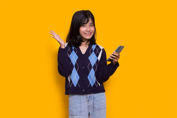 Happy Young Asian Beautiful Woman Using Mobile Phone Isolated Yellow —  Fotos de Stock