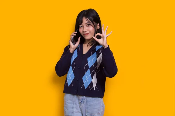 Happy Young Asian Beautiful Woman Using Mobile Phone Isolated Yellow — Fotografia de Stock