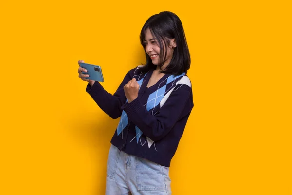 Happy Young Asian Beautiful Woman Using Mobile Phone Isolated Yellow —  Fotos de Stock