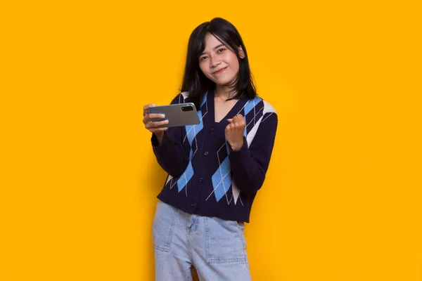 Happy Young Asian Beautiful Woman Using Mobile Phone Isolated Yellow — Stock Fotó
