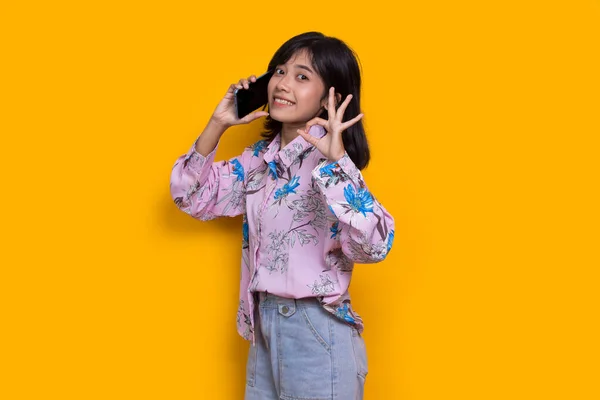 Happy Young Asian Beautiful Woman Using Mobile Phone Isolated Yellow — Fotografia de Stock