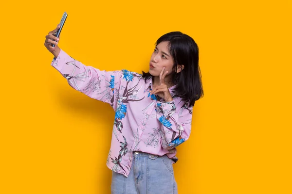 Happy Young Asian Beautiful Woman Using Mobile Phone Isolated Yellow —  Fotos de Stock