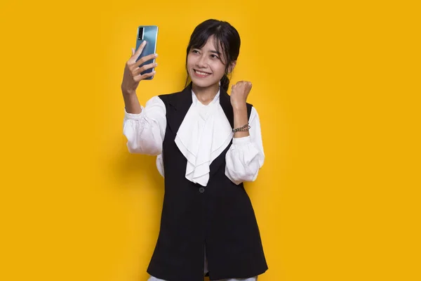 Happy Young Asian Beautiful Woman Using Mobile Phone Isolated Yellow —  Fotos de Stock