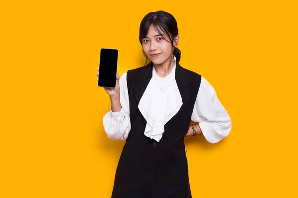 Asian Business Woman Demonstrating Mobile Cell Phone Isolated Yellow Background — Stock Photo, Image