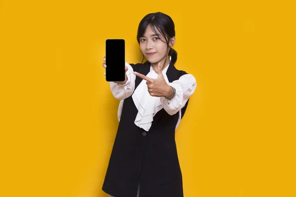 Asian Business Woman Demonstrating Mobile Cell Phone Isolated Yellow Background — Stok fotoğraf