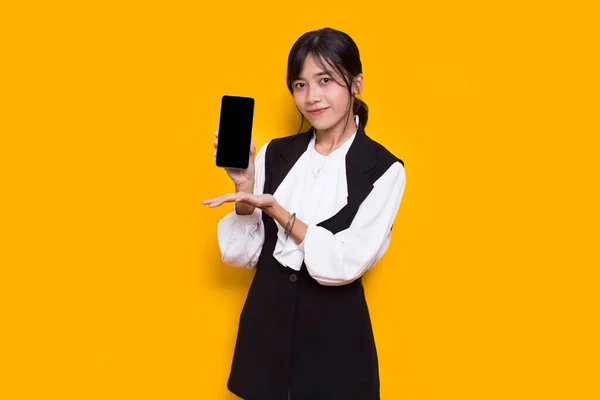 Asian Business Woman Demonstrating Mobile Cell Phone Isolated Yellow Background — Stock Fotó