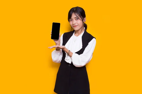 Asian Business Woman Demonstrating Mobile Cell Phone Isolated Yellow Background — Stock Photo, Image