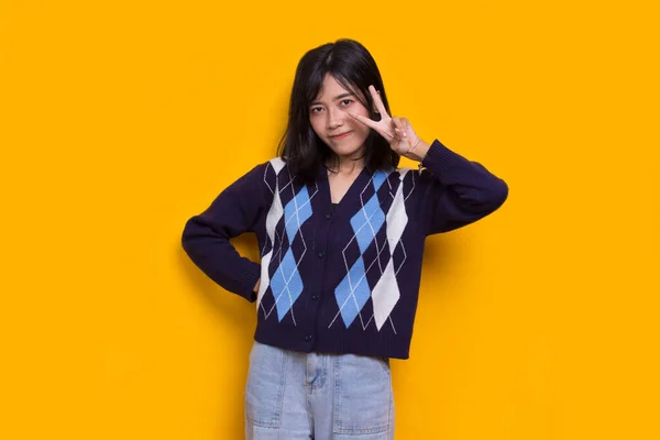 Beautiful Young Asian Girl Showing Peace Victory Hand Gesture Yellow — Stockfoto
