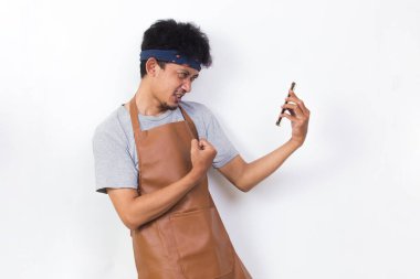 shock asian man barista bartender or waitress using mobile smartphone isolated on white background