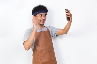 shock asian man barista bartender or waitress using mobile smartphone isolated on white background