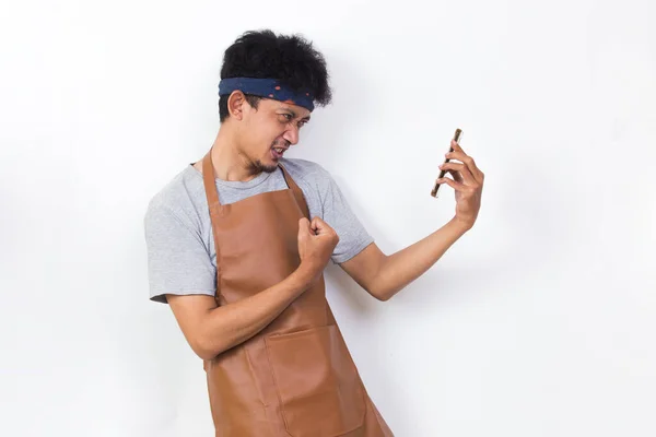 Shock Asian Man Barista Bartender Waitress Using Mobile Smartphone Isolated — Stock fotografie