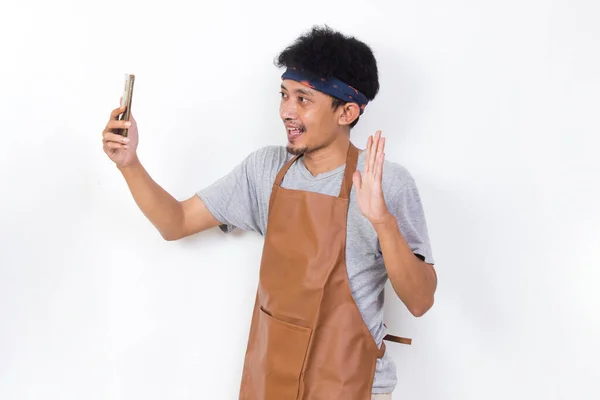 Shock Asian Man Barista Bartender Waitress Using Mobile Smartphone Isolated — Stock Fotó