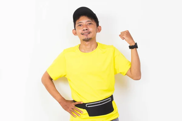 Asian Sporty Man Dressed Yellow Tshirt Showing Strong Gesture Isolated — Stockfoto