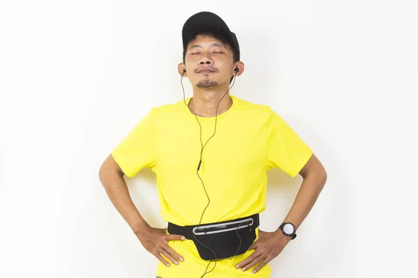 Asian Sporty Man Dressed Yellow Tshirt Listening Music Isolated White — Stock fotografie