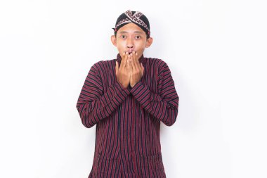 asian man with javanese traditional cloth lurik shocked isolated on white background