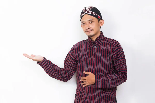 Asian Man Javanese Traditional Cloth Lurik Pointing Fingers Different Directions — Stock Fotó