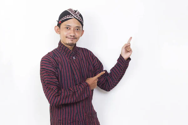 Asian Man Javanese Traditional Cloth Lurik Pointing Fingers Different Directions — Foto Stock