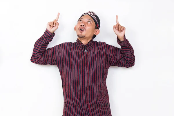 Asian Man Javanese Traditional Cloth Lurik Pointing Fingers Different Directions — 스톡 사진