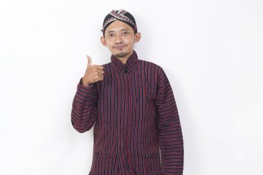 asian man with javanese traditional cloth lurik with ok sign gesture tumb up isolated on white background