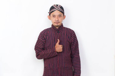 asian man with javanese traditional cloth lurik with ok sign gesture tumb up isolated on white background