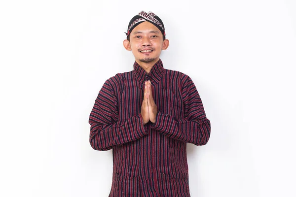 Asian Man Javanese Traditional Cloth Lurik Welcoming Guests Gretting Isolated — Stock fotografie