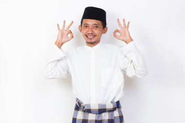 happy asian muslim man portrait showing thumbs up ok sign gesture isolated on white background