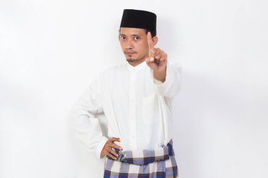 asian muslim man portrait doing stop sign with serious expression defense gesture isolated on white background